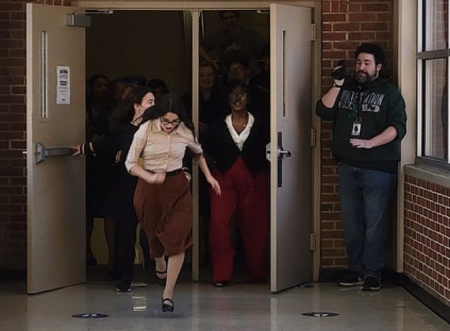 Mr. Lawrence films as actors run down the hall during the making of “Cliffhanger: Return of a Blue Ghost.” This movie took place of the 2021 play and can be viewed on YouTube. 
