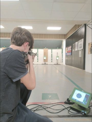 First year shooter Henry Chipley (9) finishes his last shot in the kneeling position, ending the first competition of the year. 
