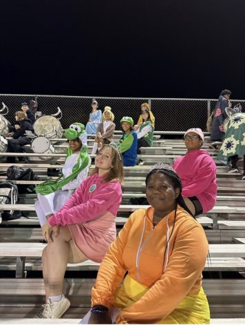  Lauren Hunter (11) (far left) along with her team members dress up in matching costumes for the last game of the season. This was the White Station vs Houston game on October 28th.

