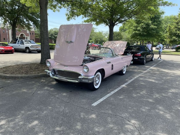 A pink Ford Thunderbird proudly stands on display at a local car show. Car shows have become a way for car enthusiasts to connect with each other and flaunt their cherished treasures.