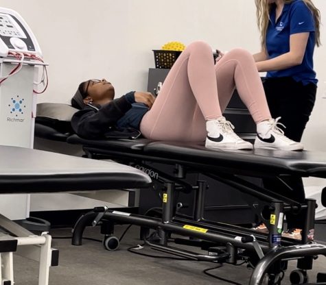 Logan Thompson (10) is at Campbell Clinic with her physical therapists next to her, doing knee exercises to increase her mobility pre-surgery. After her knee is completely healed, Thompson plans to play for MemphisLax during the summer.