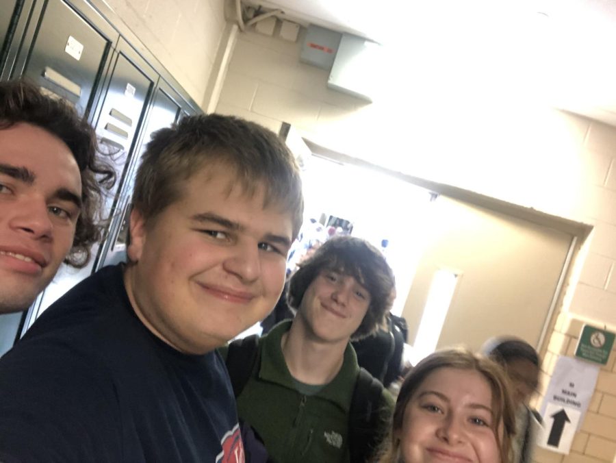 (From left to right) Garrett McNeil (11), Ben Isham (9), Clark Thomas (11) and Kylie Grant (11) stop for a selfie in the hallway. Isham met these students between classes, a time where he meets many students and staff members.