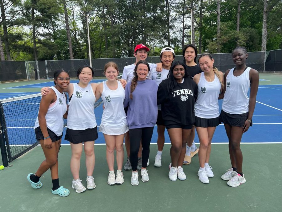 Emma Gurdien(2nd row 4th from left, a sport psychologist who does workshops and talks to the team about their mentality, stands with the tennis team on April 28th, 2023 for a district tournament. The team won all matches and was placed in first.

