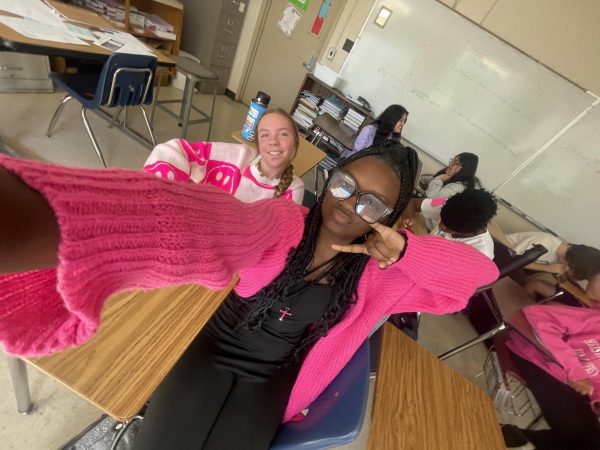 Kalice Woods (10) takes a selfie with Ella Marszalek (10) on Mean Girls day during homecoming spirit week. Woods’ sweater and unitard were both purchased from Shein.