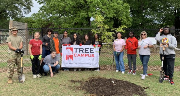Students and club sponsors pose after planting a new white oak in front of the ROTC training course. With the help of Spruce Up Sparta, White Station has been certified as a Tree Campus USA after dozens of trees were planted across the campus. 