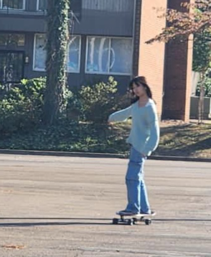 Alina Liu (11) tries to keep her balance on her cruiser skateboard after school. She saved up around $300 to buy it in 2021 and has been practicing ever since.