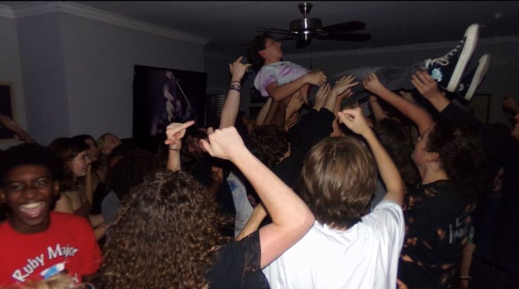 Benjamin Kay (12) is lifted into the air during a house show. Kay, who has close friendship with the band, is almost always seen dancing and encouraging the rest of the crowd to do so.
