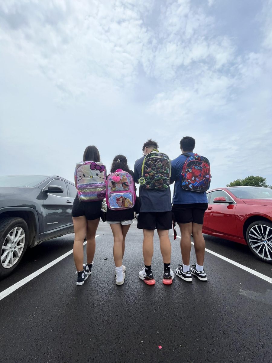 Spartan seniors pose for a quick picture showing off their backpacks. They sport Hello Kitty, Disney princesses, Teenage Mutant Ninja Turtles and Spider-Man on their bags.

