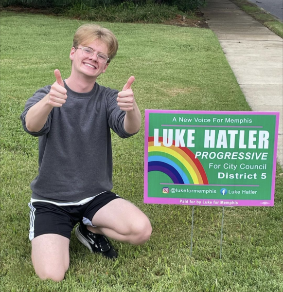Hatler poses with his newly bought signs. A multitude of signs were placed both in his district and around the school. 
