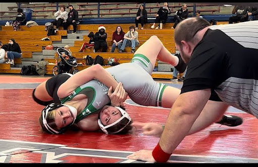 Kayleigh Angona (10) ends the match by pinning her opponent to the ground. Angona placed first overall in this tournament. 
