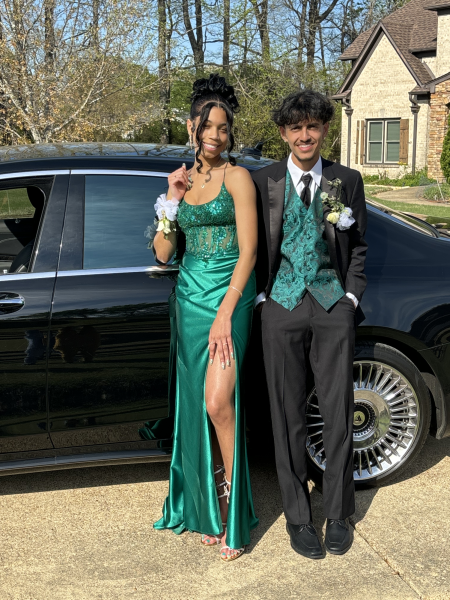 (Left to right) Arielle Brent (12) and Angel Ochoa (12) pose together in green before going to prom. Although the duo did not follow the Mardi Gras theme, they took a more “traditional” approach to prom and took inspiration from Brent’s favorite movie “The Princess and the Frog”.