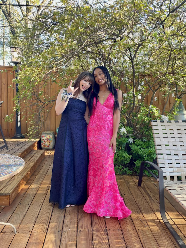 (On the right) Summer Cherry (12) wore a pink dress on the night of prom despite not initially wanting to go until she visited Glitz, a boutique in Nashville, over spring break. 