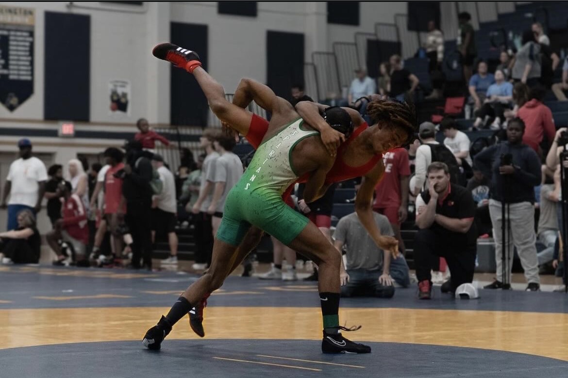 Braxton Gray (12) takes down his opponent in a preseason wrestling meet at Arlington High School. Wrestlers are required to make the weight class they are wrestling at; if not, they are disqualified.