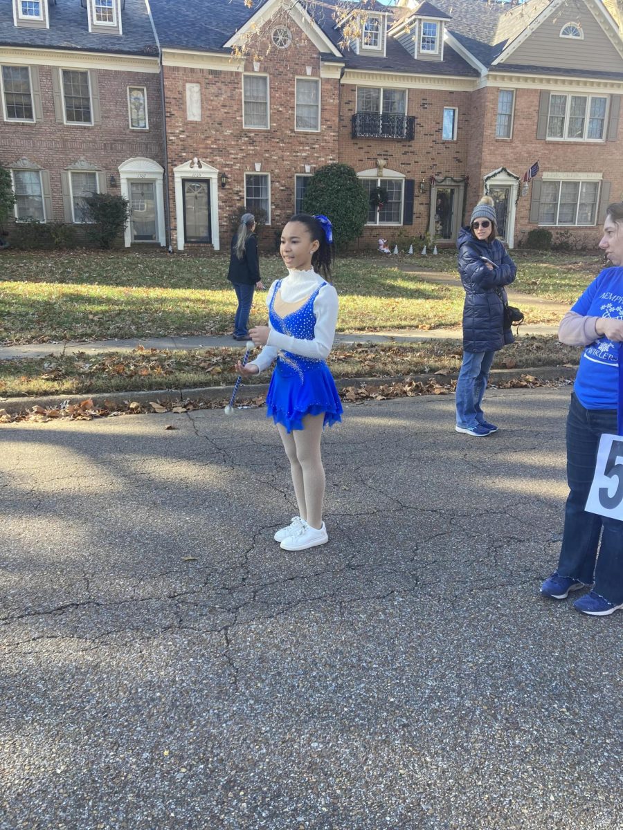 Jackson performs as the featured twirler for a parade. She has participated in many such parades in her twirling career.