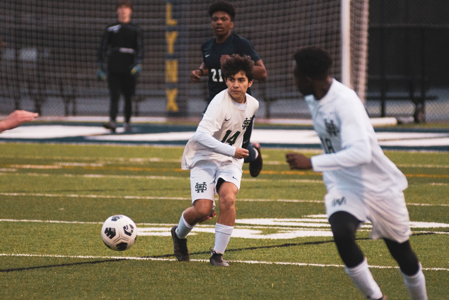 The soccer team dribbles the ball to the opposing team’s side, putting them on defense. Many players play club soccer to compete and stay in shape during the off season.