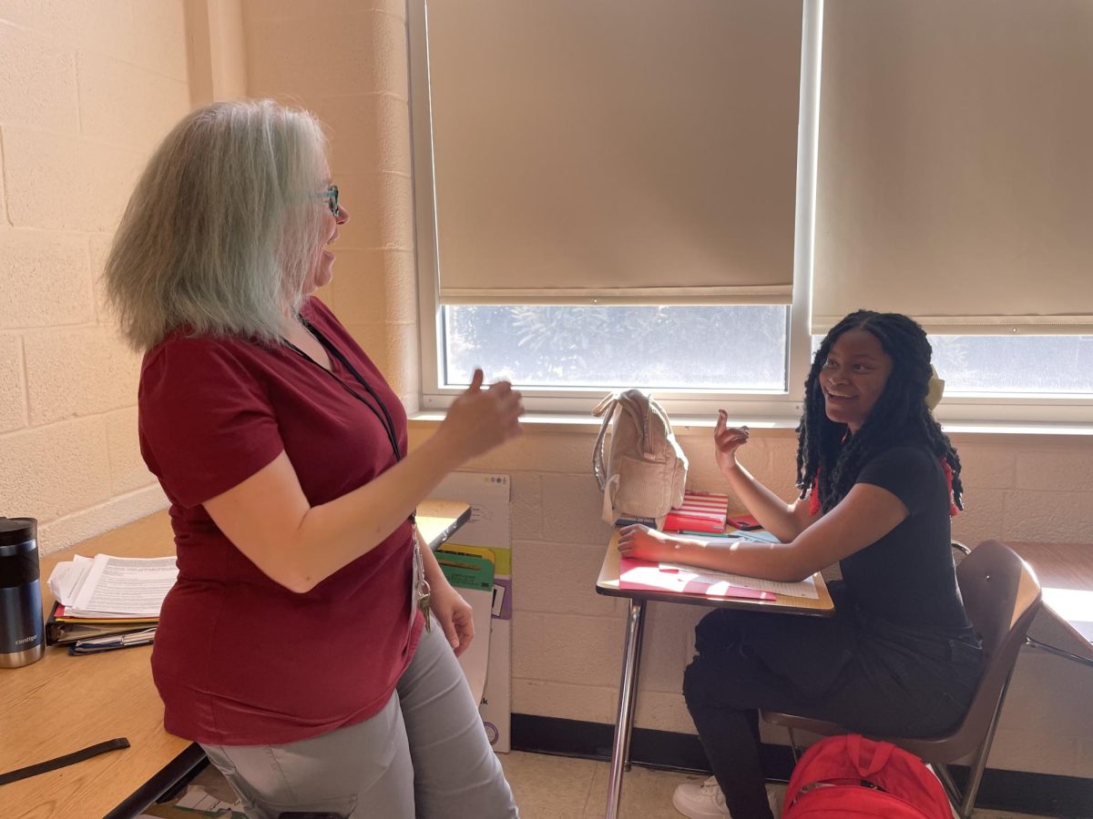 Kimberly Feldmayer, one of White Station’s teachers from the Hard of Hearing (HOH)/Deaf Department, communicates with Makilah Winfield (12) through sign language. Winfield was assisted by Feldmayer for an assignment in one of Erika Sugarmon’s classes. 
