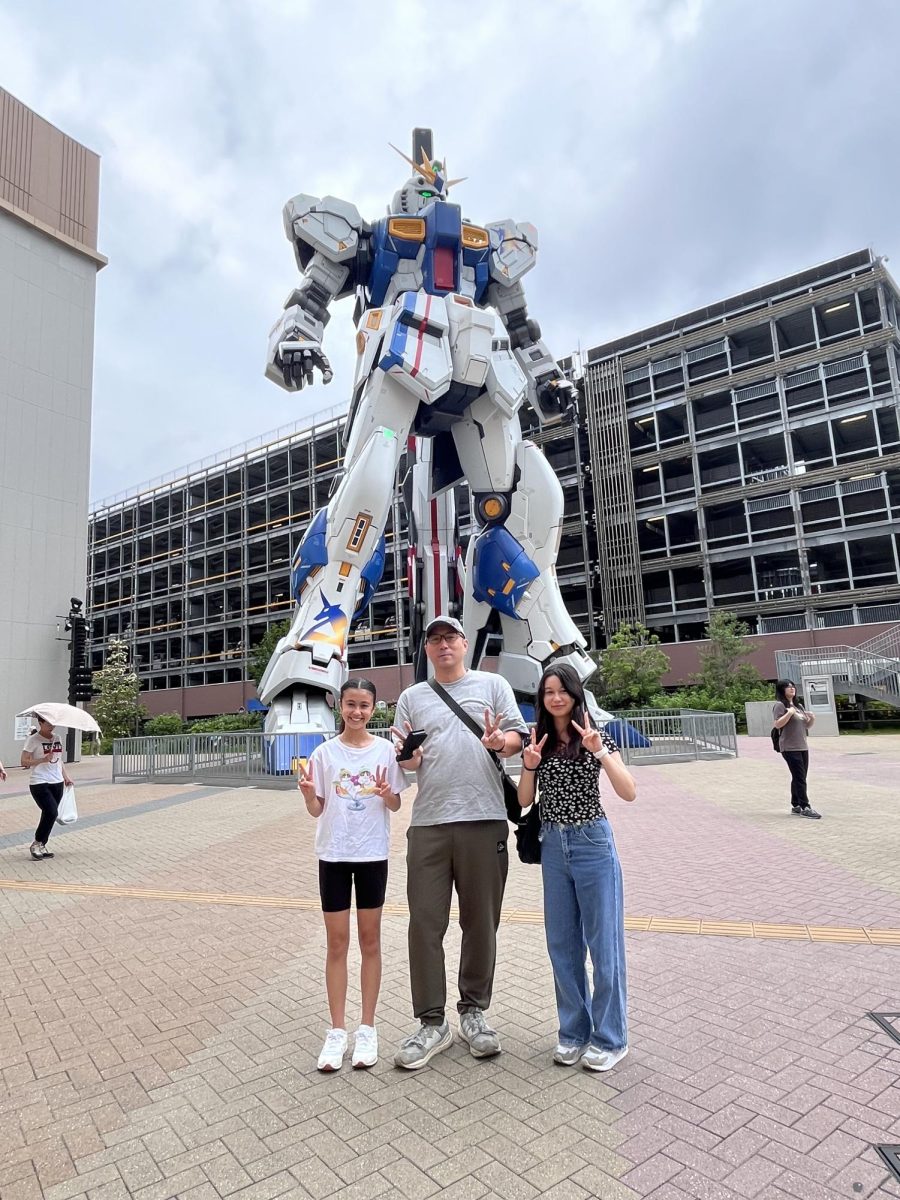 (Right) Aylla Wexler (11) and her family pose in front of a giant Gundam figure during a 2023 trip to Japan. Wexler, who is half Japanese, and her family frequently travel to Japan to visit extended family.