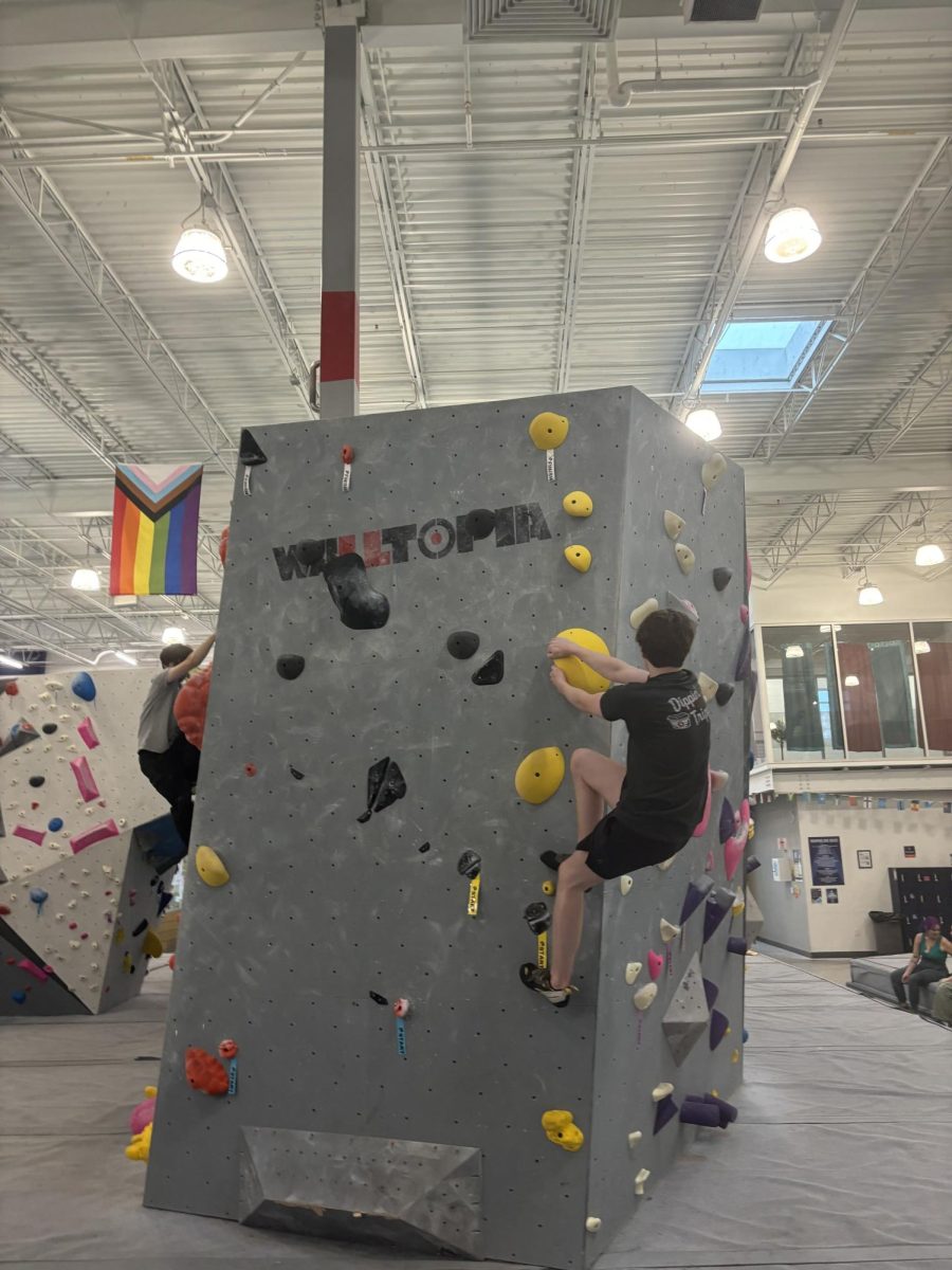 Kenneth Harms (12) attempts a dyno problem. Dyno problems require the climber to jump to progress through the problem.