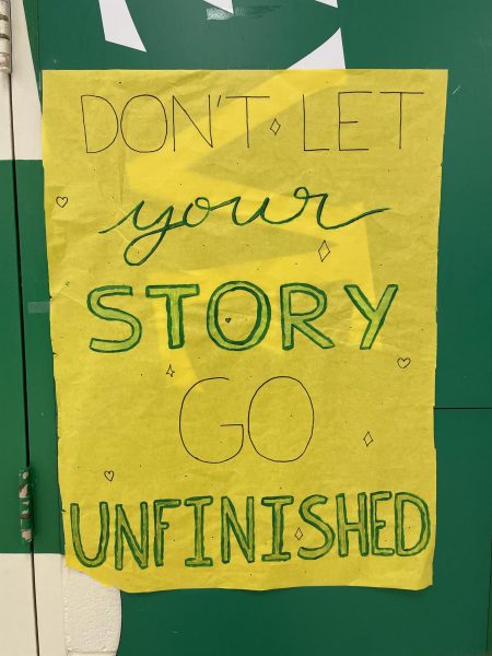 A poster with the titular message of Storyunfinished rests in the school cafeteria. Aisha Ceesay (12) and Adaria Crutcher (12) came up with the motto to encourage students to keep pushing forward and live their full story.