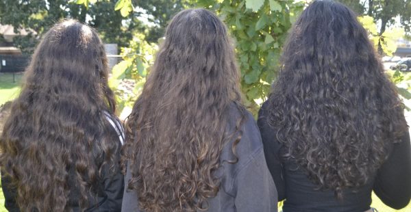 Samantha McGuire (9), Lia Turner (10), and Amirah Alshujaa (10) are embracing their curls. They each have a unique style of curly hair.
