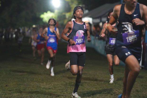 Second-place runner, Kameron Kearney (12), runs towards the end, exhausted during the cross-country race. Kearney thought of the finish line for motivation as he ran The Frank Horton Trail Race at Shelby Farms.