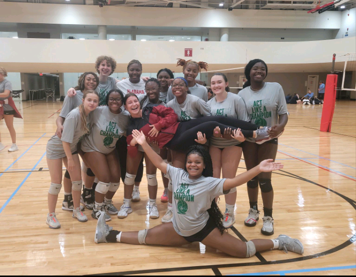 The varsity volleyball team captures a moment with their mentors from the skills camp at the University of Albama. They spent three days with an Albama player and mentor. getting new perspectives on playing volleyball. 