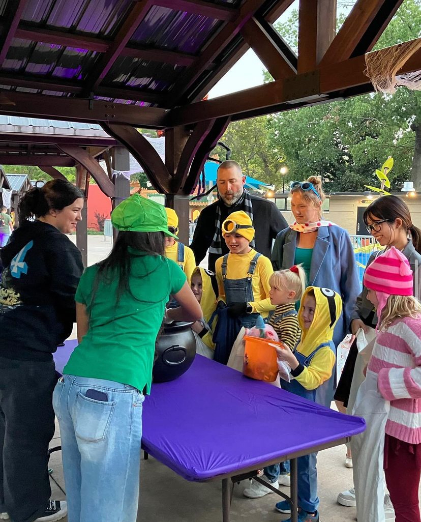 White Station High School Key Club members give out candy to a family at the Memphis Zoo’s Zoo Boo. The family is dressed as the Gru family from the “Despicable Me” film franchise.