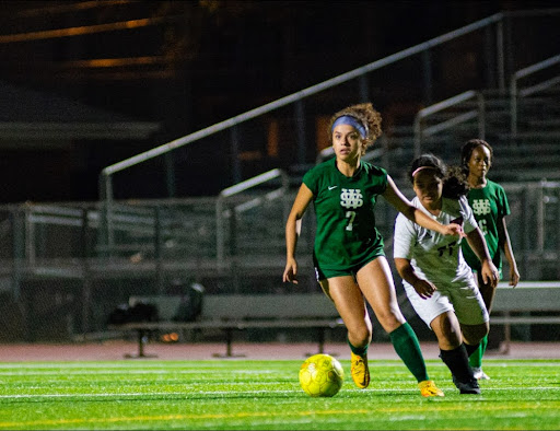 Celeste Cruz (12) dribbles the ball during her junior year game against Kingsbury High School. The Lady Spartans won this game 9-0.