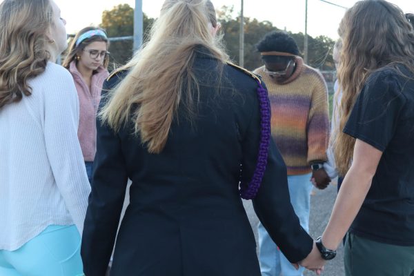 Members of the White Station High School prayer group begin praying in the senior parking lot before the first bell. They have gathered every Wednesday for the past few months to pray for individual requests and the well-being of the school. 