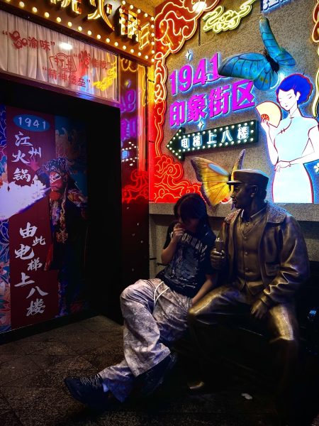  Henry Tang (11) visits a courtyard in China that contains many things to view. He sits beside a statue with a sign that mentions Fujian, meaning “happy establishment.”