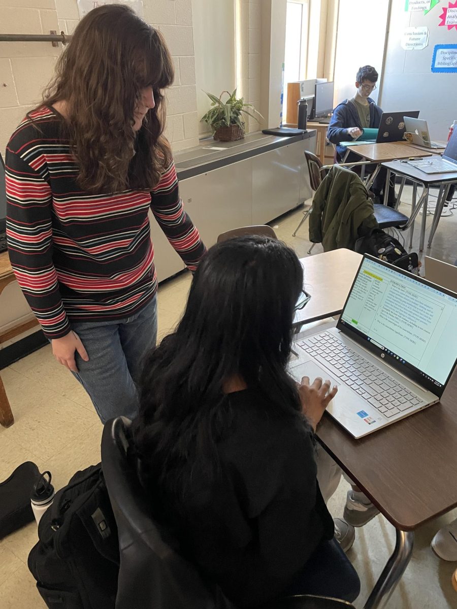 Emily Kennedy (12), pictures on the left, is a teacher assistant (TA) for Advanced Placement Seminar. As a TA, Kennedy gives students feedback on their work, like research papers, citations and PowerPoints. 
