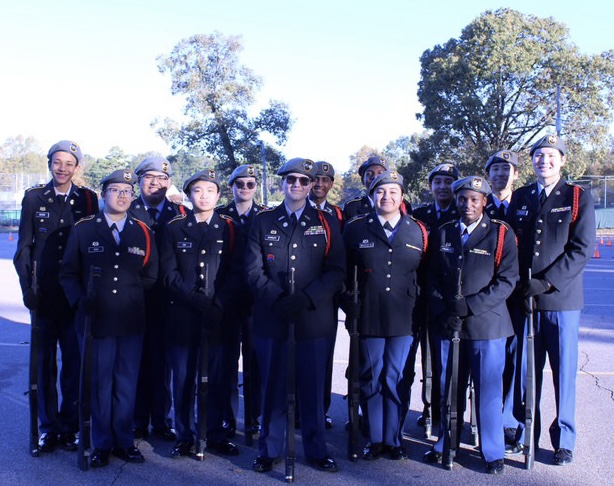 Theo Scarlett (11) poses with his Armed Drill Team. He joined the team in his freshman year, and Scarlett became the commander this year.  