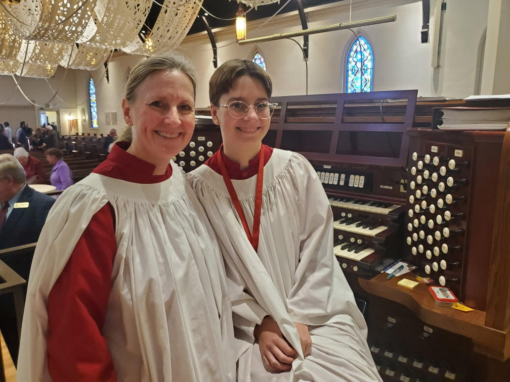 Zoe Bondi (10) sits with her organ teacher, Kristin Lensch, near the organ that Bondi performs on. Bondi has played the organ for two years. 