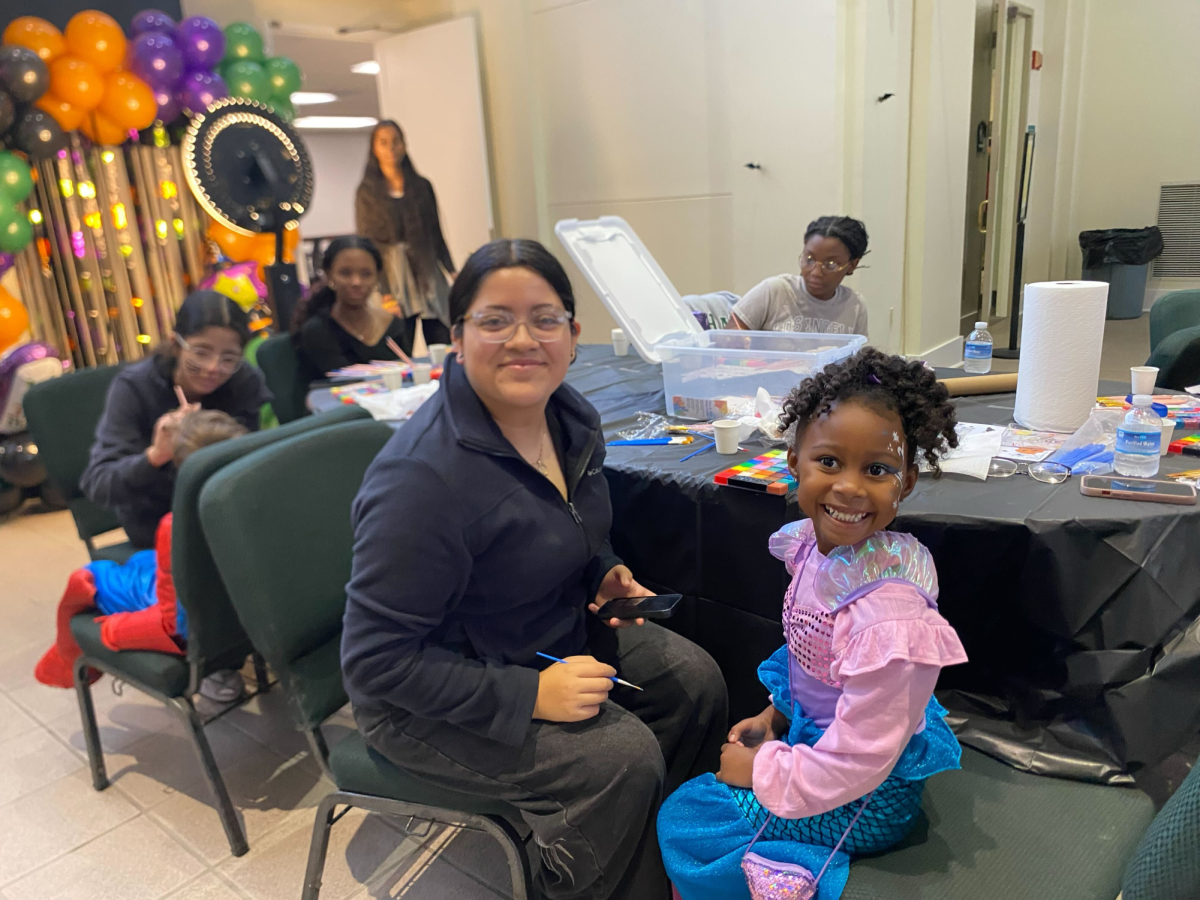 Valeria Medina (11) paints kids' faces. Her group volunteered at Lindenwood Church's Truck or Treat for service learning.