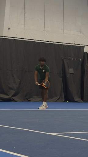 Tennis team co-captain Aarav Ravva (11) prepares to serve to Charlie Russell (11) in a practice match. Ravva hopes to motivate his teammates to be consistent in attending practice, despite busy spring scheduling.