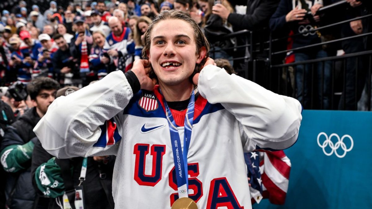 Jack Hughes smiles with his gold medal after scoring the overtime goal to win the final against Canada. Hughes had his tooth knocked out earlier in the match, and his perseverance helped the United States men’s hockey team win their first gold medal in 46 years.