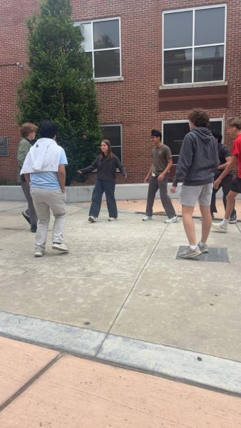 A group of students gather in the courtyard of White Station High School to play Hacky Sack. Hacky Sack can be played with two or more participants.