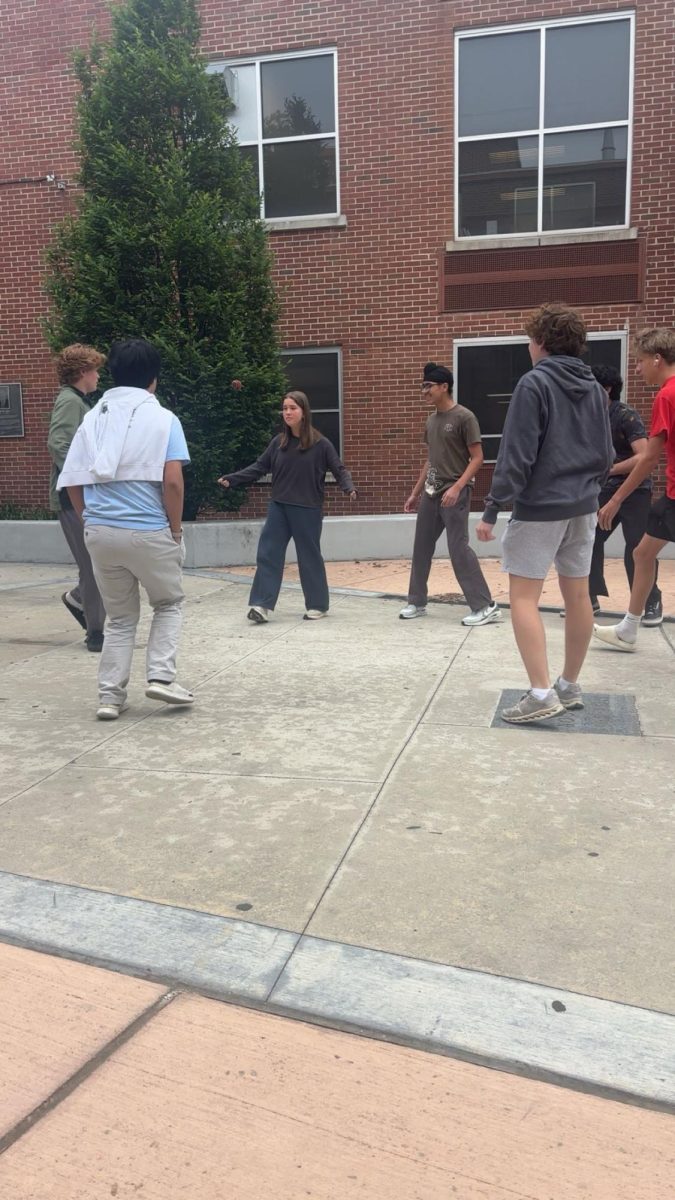 A group of students gather in the courtyard of White Station High School to play Hacky Sack. Hacky Sack can be played with two or more participants. 